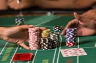 A baccarat table stacked with casino chips.