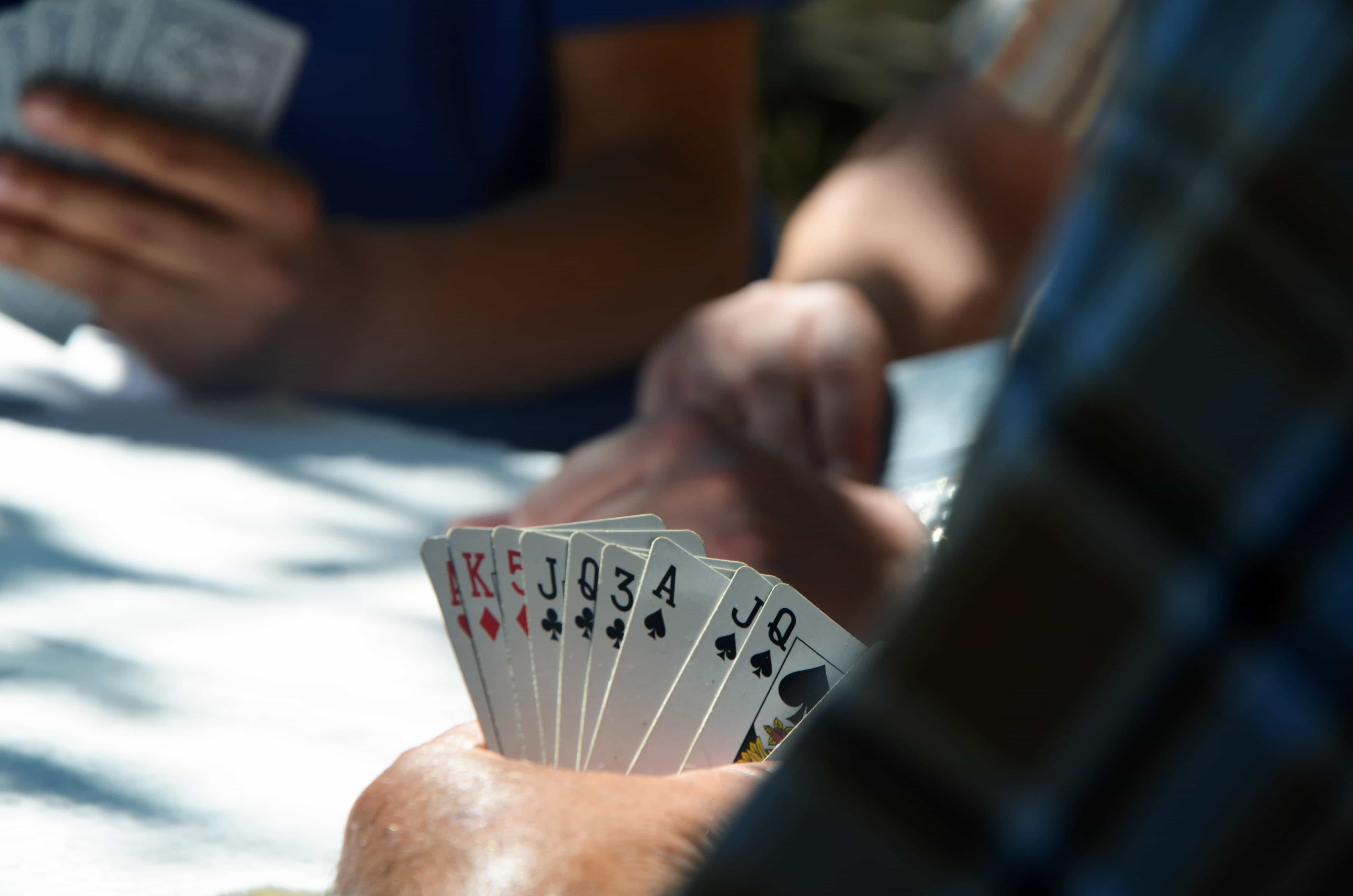 A group of people playing cards.