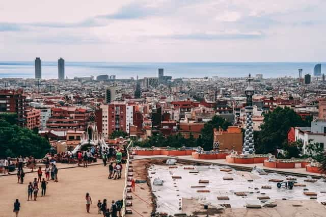 A crowd of people gathers in a plaza in Barcelona, Spain.