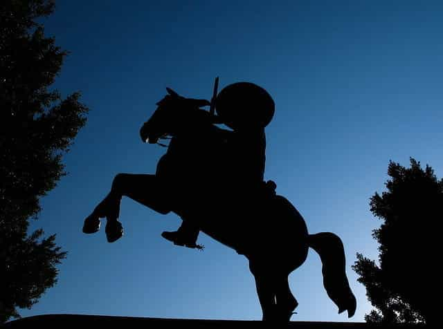 A silhouette of a monument featuring a man riding a horse in Mexico.