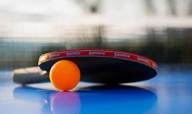 Table tennis paddle and ball.