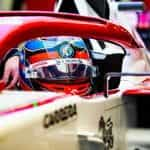 The driver and cockpit of an Alfa Romeo F1 car.