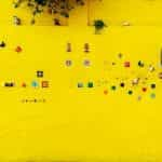 A bright yellow wall is adorned with decorations outside a house in Salta, Argentina.