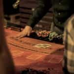 A casino dealer dealing a game of Blackjack.