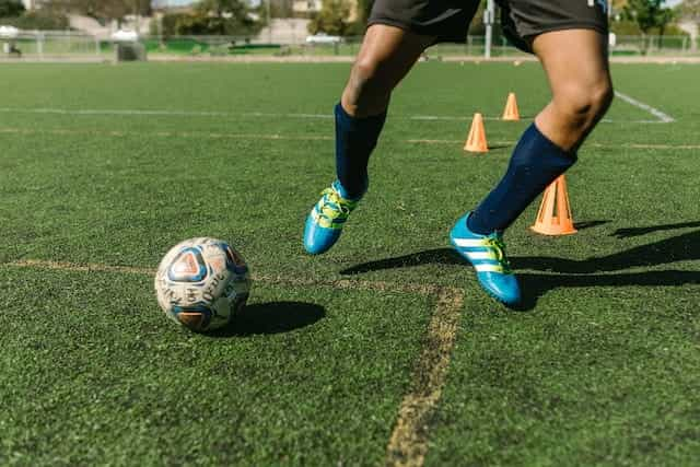 A footballer training on a pitch.