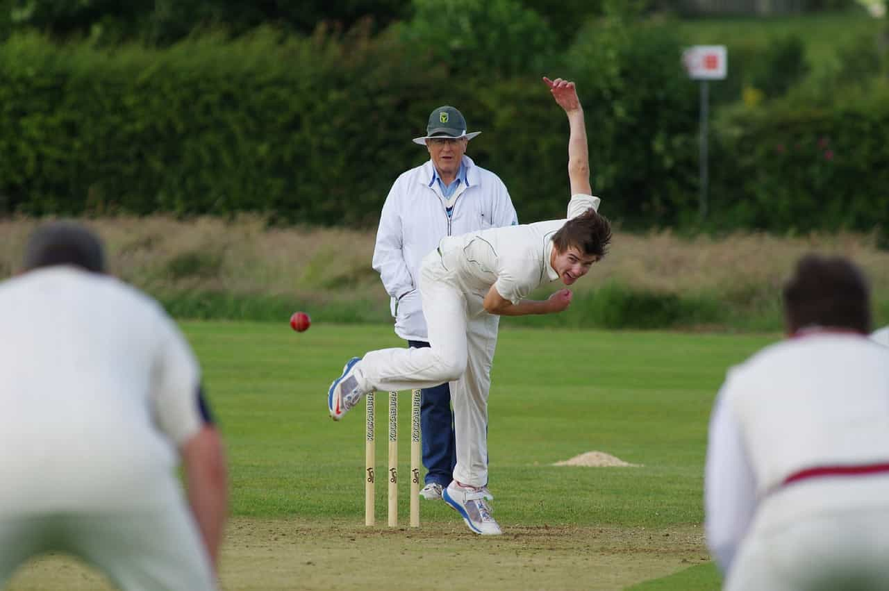 Cricket player bowling the ball