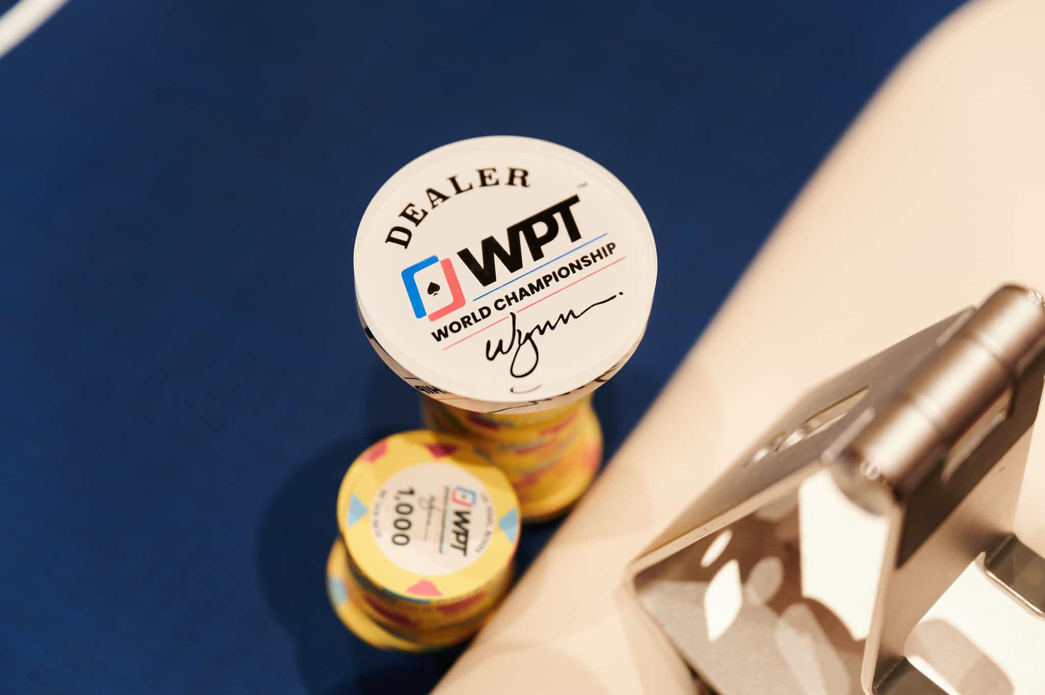 WPT branded poker chips and a dealer button.