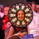 A darts fan having lots of fun at a live event.